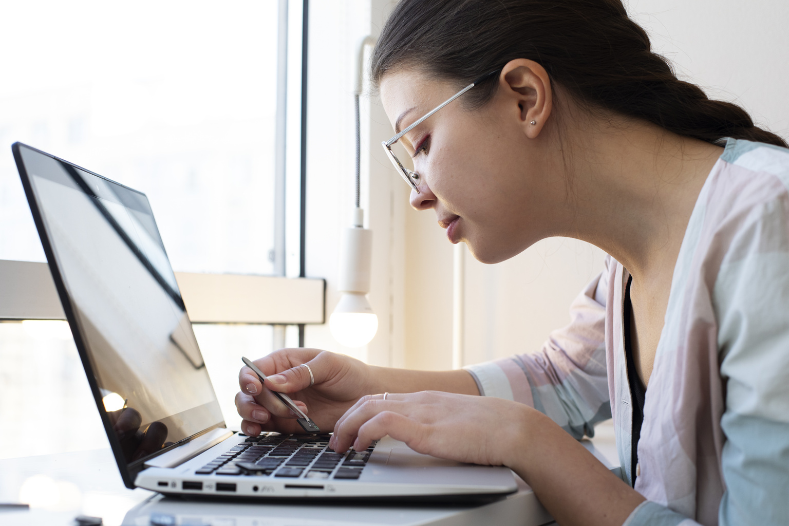 young-woman-cleaning-her-laptop-key-board.jpg
